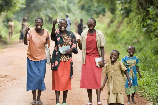 Joyful group walking down a rural path